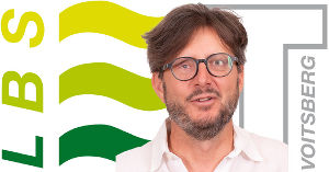 Portrait von Manfred Mazgan vor LBS Voitsberg Logo