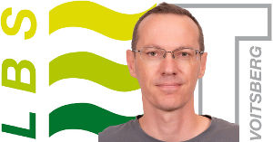 Portrait von Bernhard Wanz vor LBS Voitsberg Logo